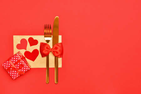 Beautiful table setting for Valentine's Day on red background