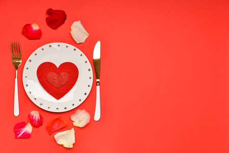 Beautiful table setting for Valentine's Day on red backgroundの写真素材