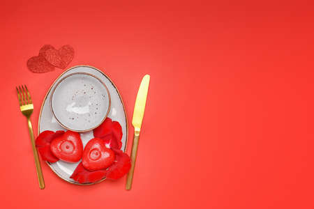 Beautiful table setting for Valentine's Day on red backgroundの写真素材