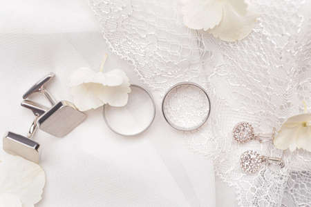 Beautiful wedding rings with jewelry on white clothの写真素材