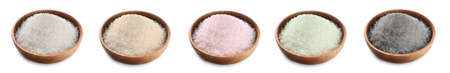 Bowls with different salt on white background