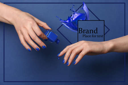 Hands with stylish nail polish on color background with space for textの写真素材