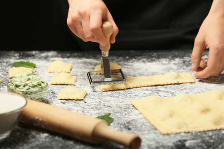 Woman preparing tasty ravioli on tableの写真素材