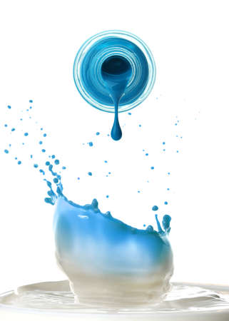 Open bottle with dripping nail polish and splashes on white backgroundの写真素材