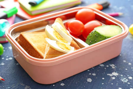School lunch box with tasty food on tableの写真素材
