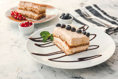 Plate with tasty tiramisu on white backgroundの写真素材