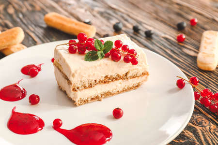 Plate with tasty tiramisu on tableの写真素材