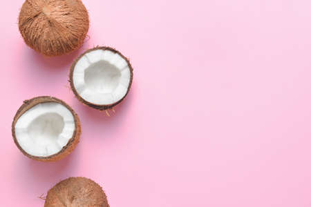 Ripe coconuts on color backgroundの写真素材