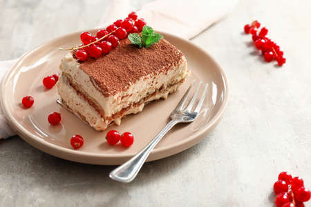 Plate with tasty tiramisu on tableの写真素材