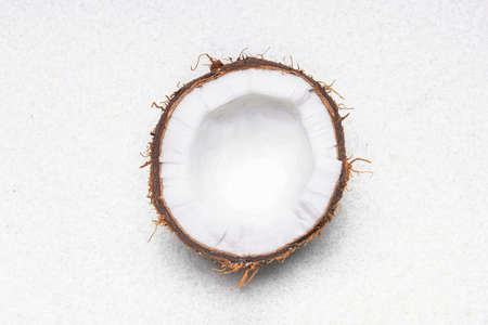 Half of ripe coconut on light backgroundの写真素材