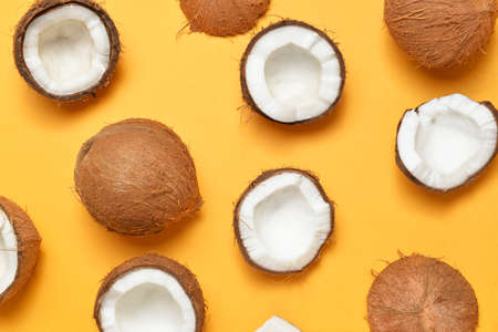 Ripe coconuts on color background