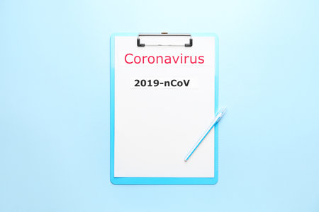 Paper sheet with text Coronavirus on color background