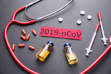 Stethoscope and medicines for Coronavirus on dark backgroundの写真素材