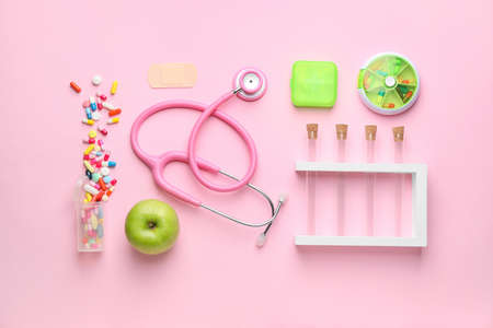 Set of medical supplies with apple on color backgroundの写真素材