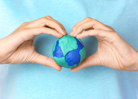 Woman with model of Earth, closeupの写真素材