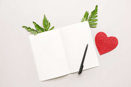 Empty notebook with pen on white backgroundの写真素材