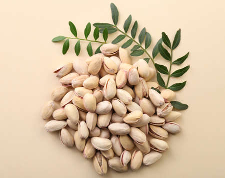 Tasty pistachio nuts on color backgroundの写真素材