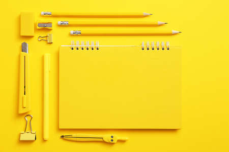 Notebook with school supplies on color backgroundの写真素材