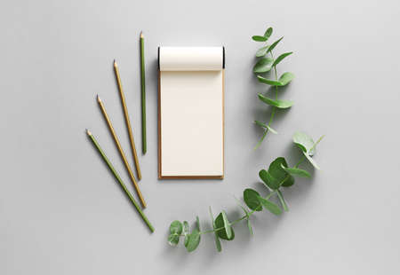 Notebook with pencils on gray backgroundの写真素材