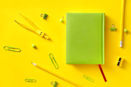 Notebook with school supplies on color backgroundの写真素材
