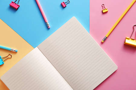 Notebook with school supplies on color backgroundの写真素材