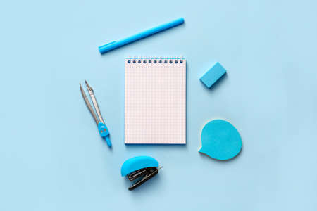 Notebook with school supplies on color backgroundの写真素材