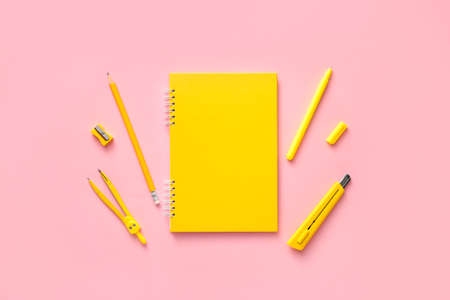 Notebook with school supplies on color backgroundの写真素材