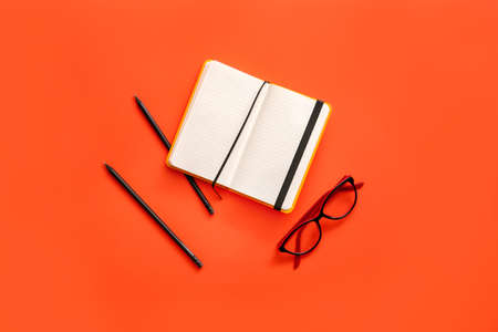 Notebook with pencils and eyeglasses on color backgroundの写真素材