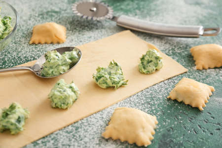 Preparing of tasty ravioli on color backgroundの写真素材