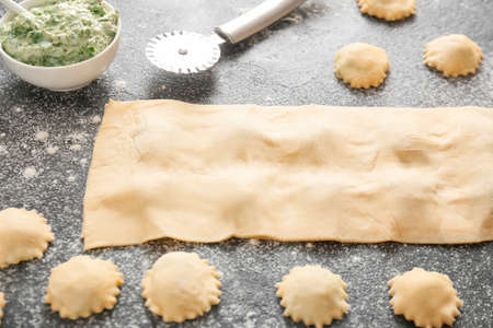 Preparing of tasty ravioli on dark backgroundの写真素材