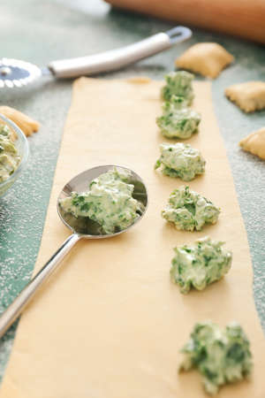 Preparing of tasty ravioli on color backgroundの写真素材