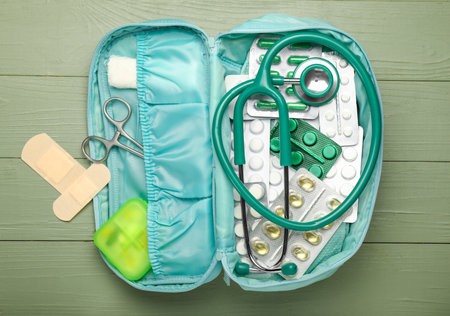 First aid kit on color wooden backgroundの写真素材