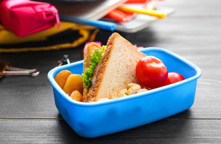 School lunch box with tasty food on wooden backgroundの写真素材