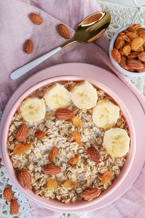 Bowl with tasty sweet oatmeal on trayの写真素材