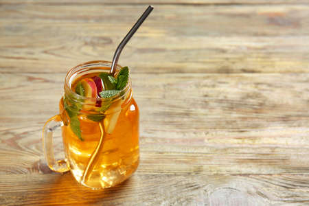 Mason jar of cold tea on wooden tableの写真素材