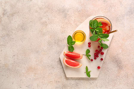 Glass of cold tea on light backgroundの写真素材