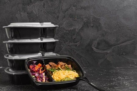 Containers with healthy food on dark backgroundの写真素材