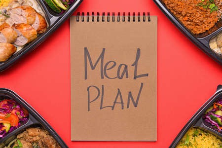 Containers with healthy food and meal plan on color background