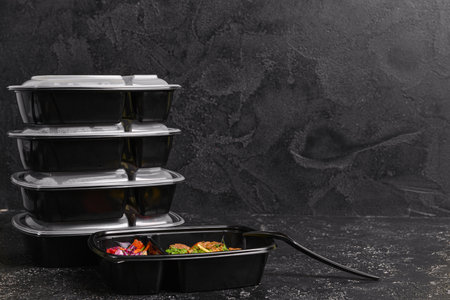 Containers with healthy food on dark backgroundの写真素材
