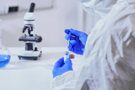 Scientist with vaccine in laboratory. Concept of epidemicの写真素材