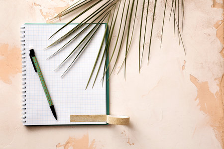 Notebook with pen and palm leaf on white backgroundの写真素材
