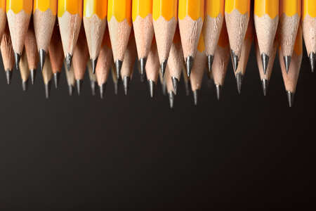 Many pencils on dark backgroundの写真素材