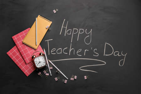 Set of school stationery and text HAPPY TEACHER'S DAY on dark backgroundの写真素材