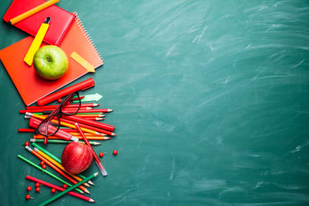 Set of stationery on school blackboardの写真素材