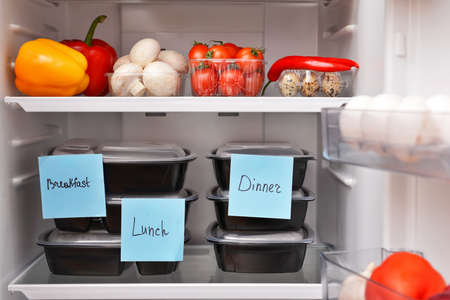 Containers with healthy food on shelf in fridgeの写真素材