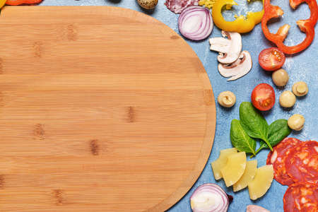Ingredients for tasty pizza with board on color backgroundの写真素材