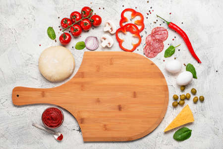 Ingredients for tasty pizza on light backgroundの写真素材