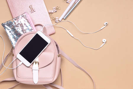 Set of school supplies with backpack and mobile phone on color backgroundの写真素材