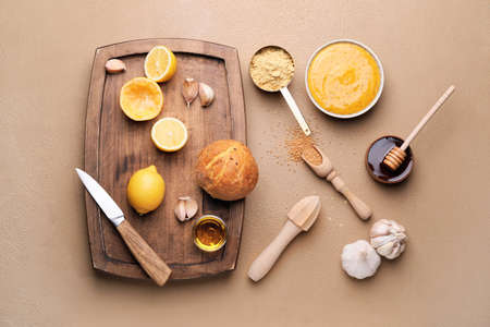 Tasty honey mustard sauce with ingredients on color backgroundの写真素材