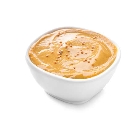 Bowl of tasty honey mustard sauce on white backgroundの写真素材
